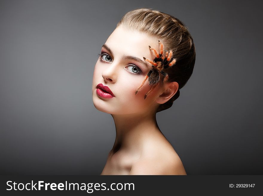 Portrait of Woman with brachypelma smithi Spider creeping on her Face