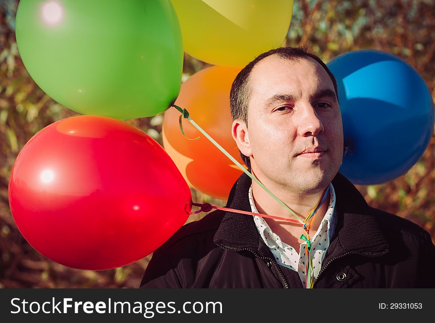 Young man with lot of balloons outdoor. Young man with lot of balloons outdoor