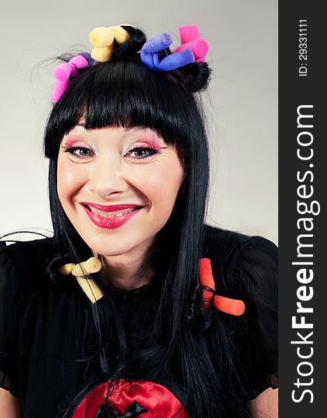 Funny portrait of young woman with curlers on her head. Funny portrait of young woman with curlers on her head