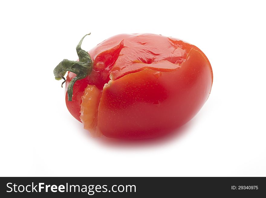 Single crushed tomato isolated on white background