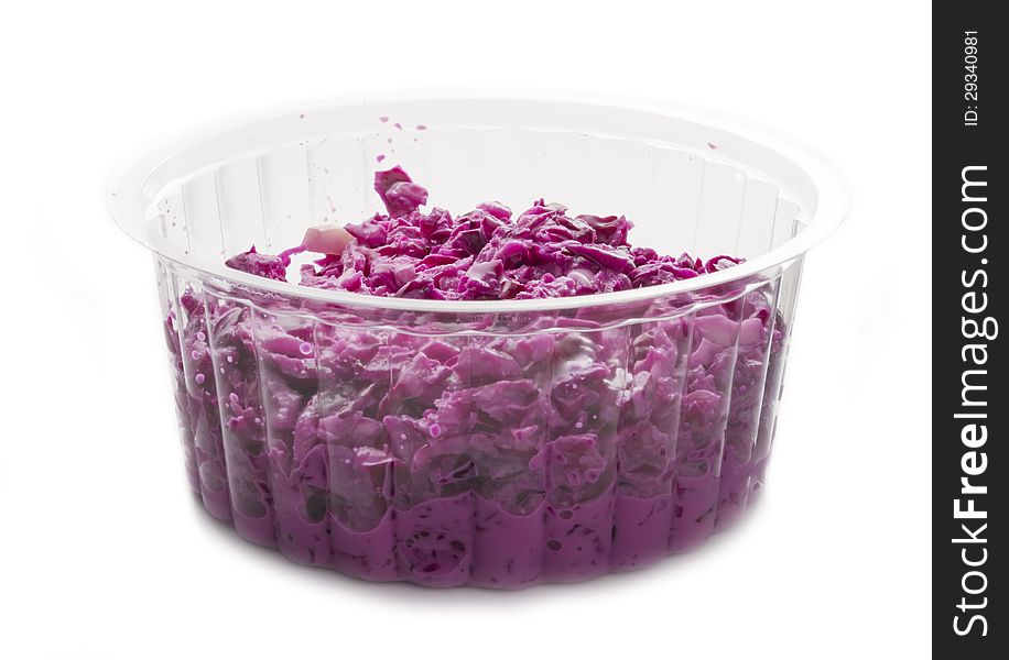 Red cabbage salad in plastic bowl isolated on white