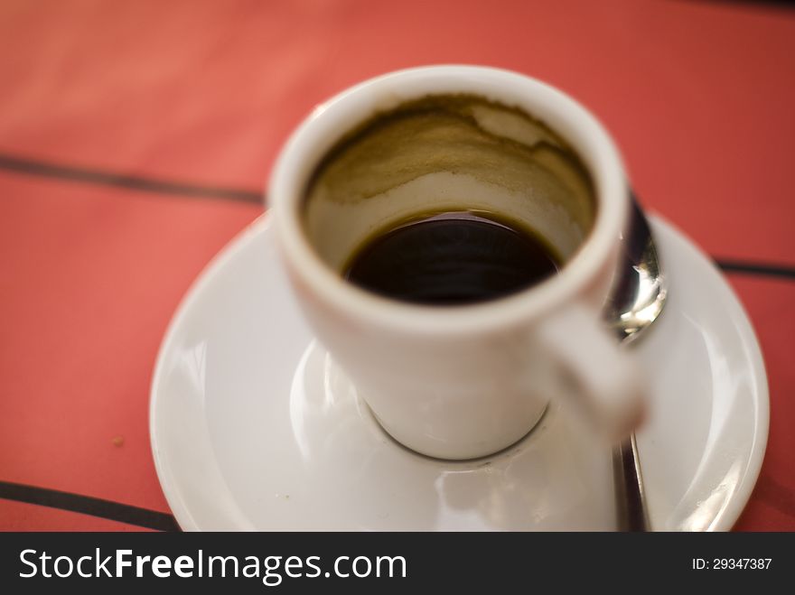 Cup with coffee on red background