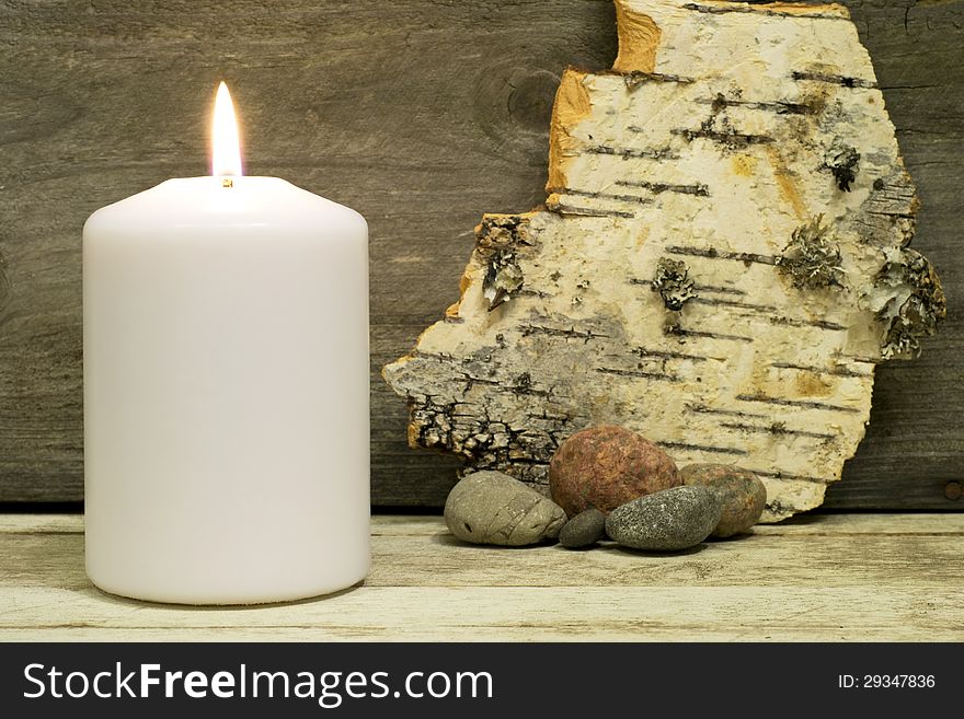 Candle, birch bark and stones