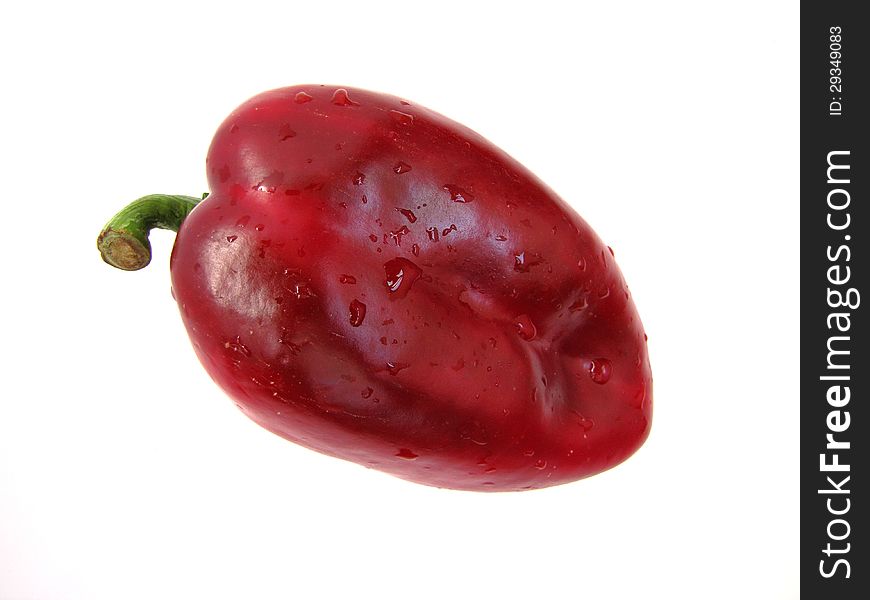 Big, red pepper with water drops isolated on a white background