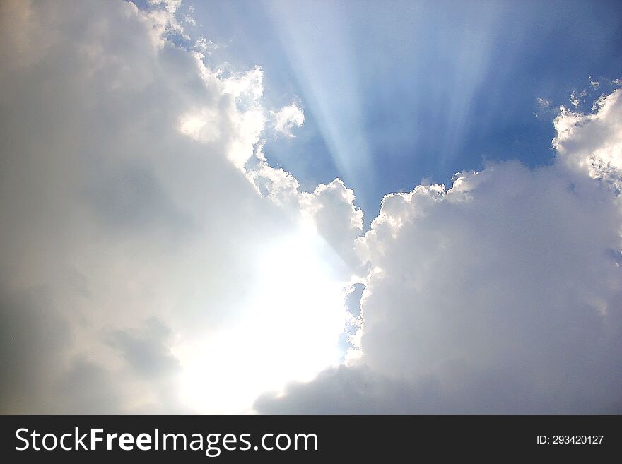 blue sky with white clouds and sun ray, nature cloudscape background