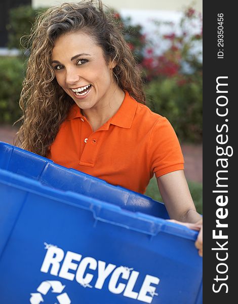 Happy pretty woman holding recycle bin smiling