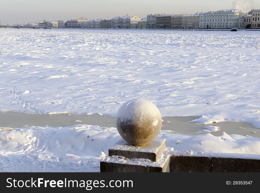 Winter cityscape of St.Petersburg by winter time with frozen Neva river and Winter Palace building behind