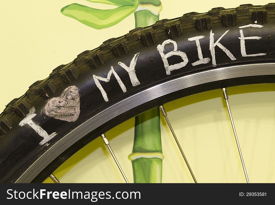 I love my bike phrase handwritten on the black wheel tire