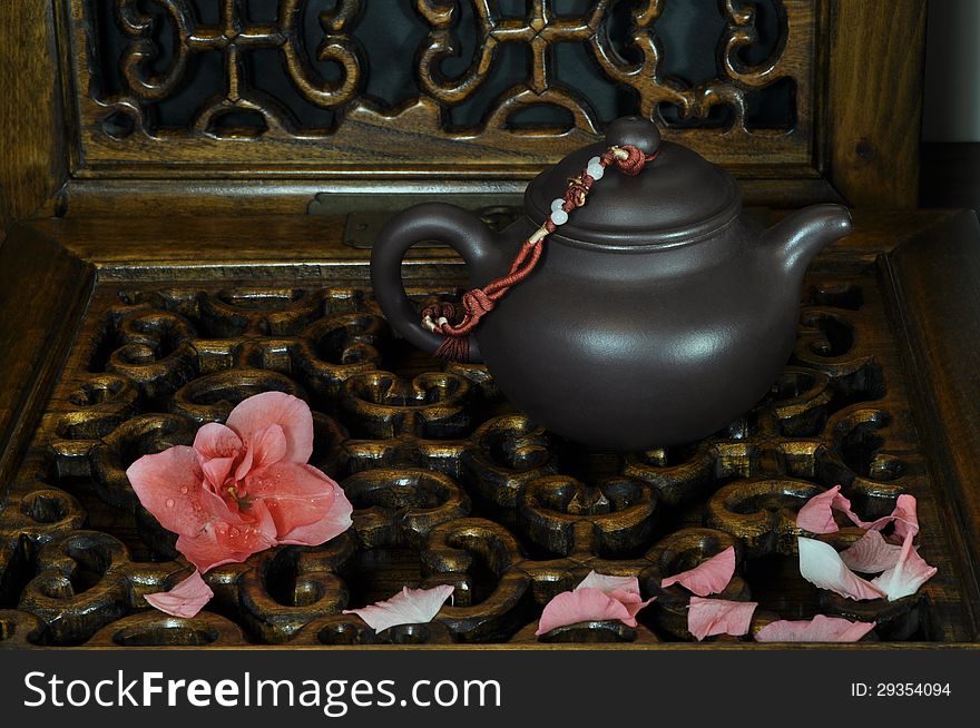 Green tea, falling flowers on carved woodwork. Green tea, falling flowers on carved woodwork