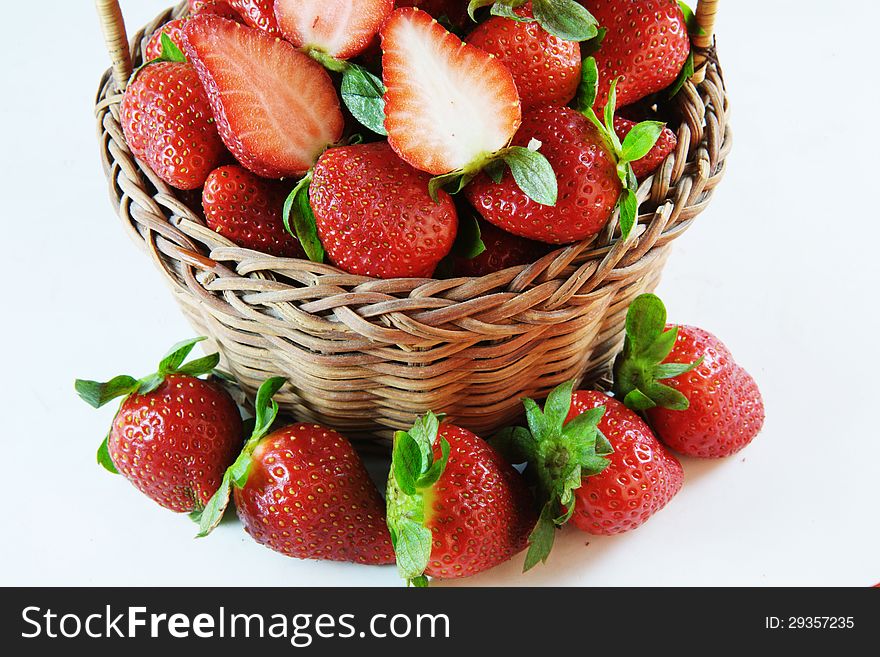 Several strawberries and bamboo basket