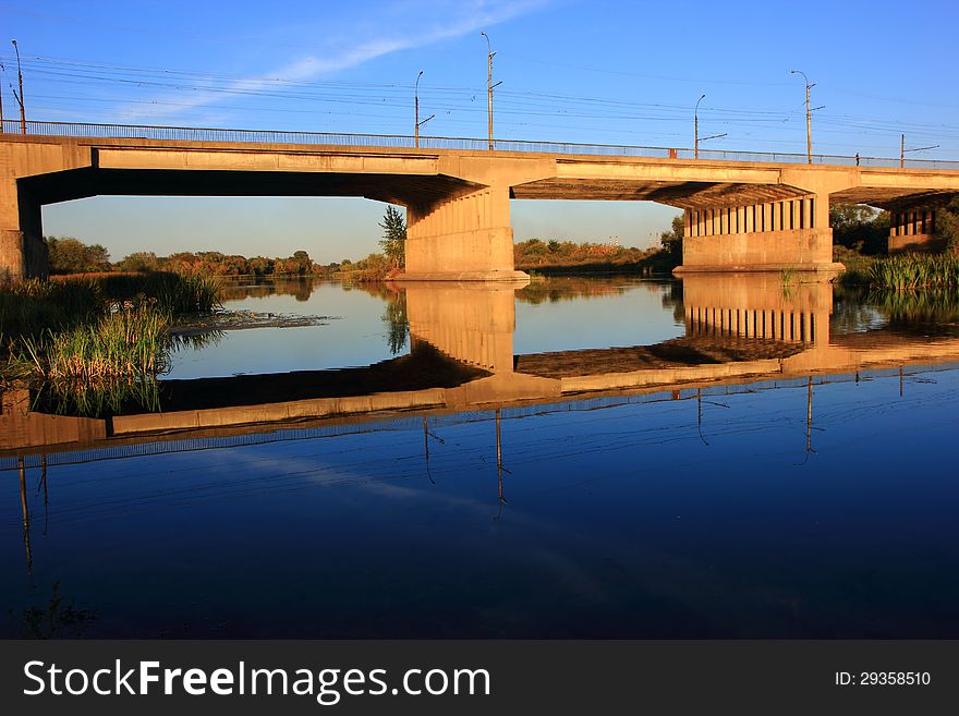 Showing traffic and pedestrian bridge in river smooth surface. Showing traffic and pedestrian bridge in river smooth surface.