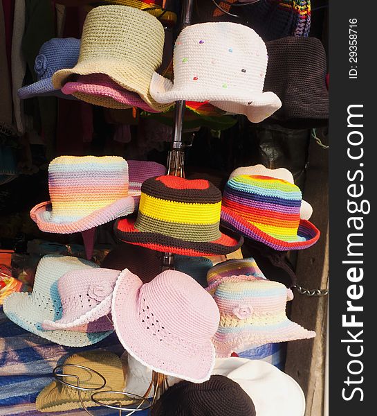 Colorful woven hat hanging on shop.