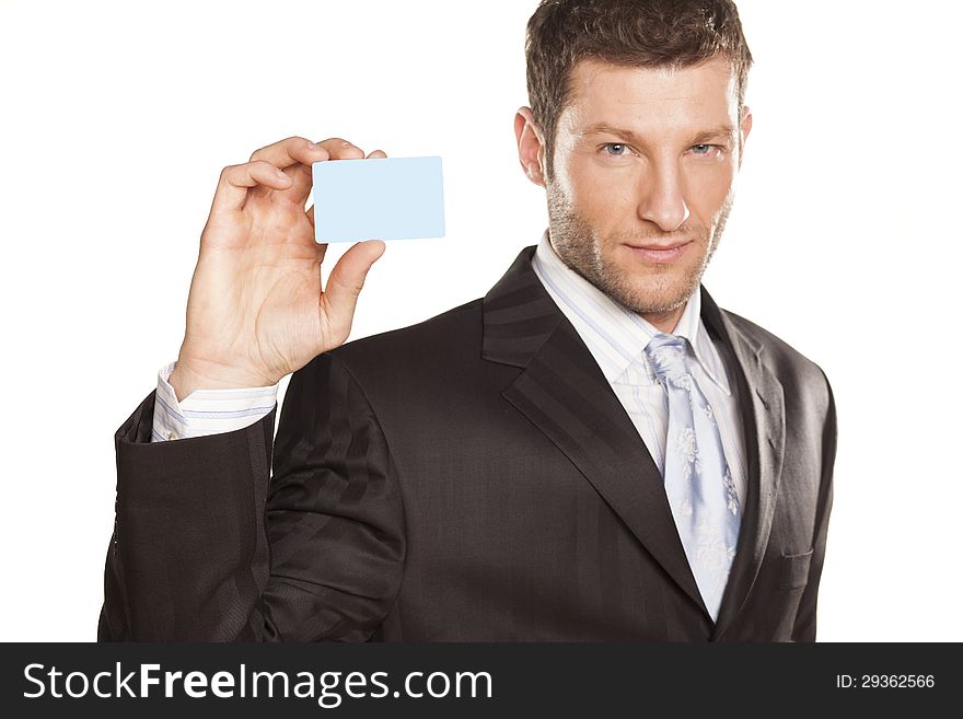 Smiling handsome businessman showing a credit card. Smiling handsome businessman showing a credit card