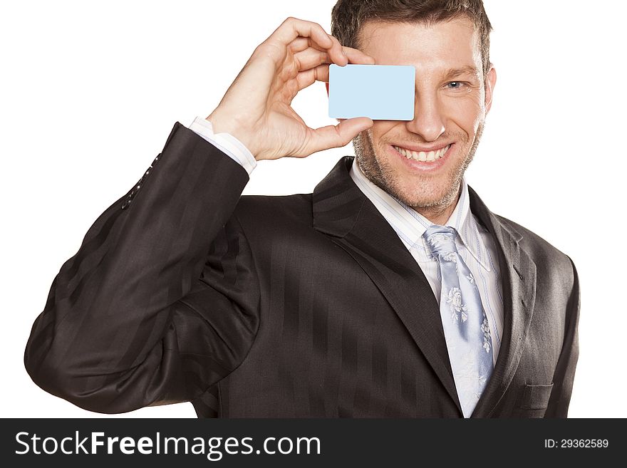 Smiling handsome businessman showing a credit card. Smiling handsome businessman showing a credit card