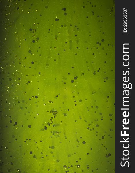 Green abstract background with air bubble, dark particles, flares