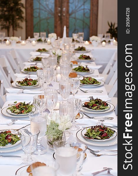 Vertical: Salads Served On White Table Cloth For Wedding Reception