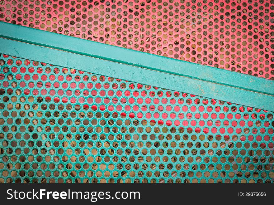 Colors of green and red metal sieve background