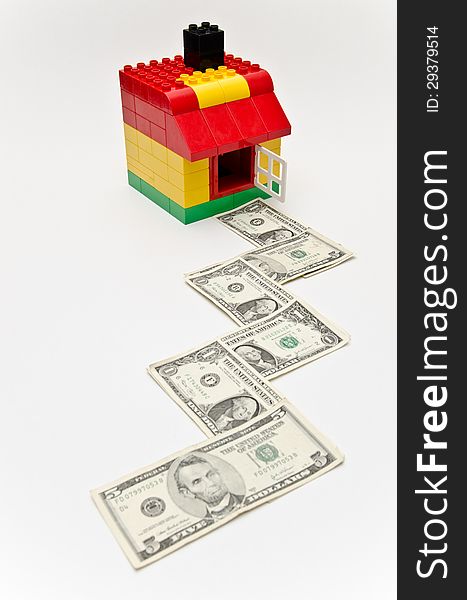 LEGO house and money. Dollars in front of the house. LEGO house and money. Dollars in front of the house.