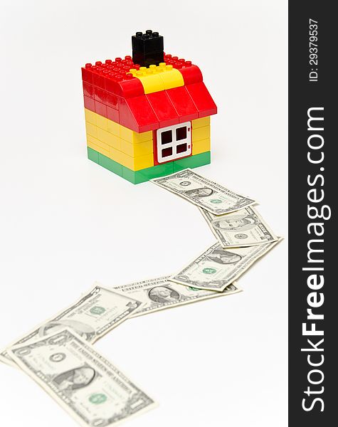 LEGO house and money. Dollars in front of the house. LEGO house and money. Dollars in front of the house.