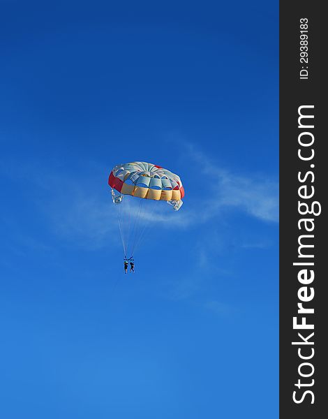 Beach parachute floating on blue sky. Beach parachute floating on blue sky