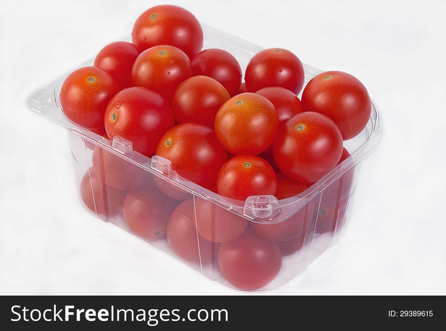 Set tomatoes in a transparent plastic bag isolated on white