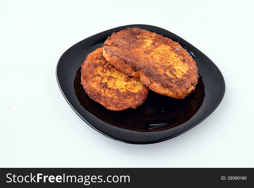 Quick breakfast, toasted bread and eggs in black plate  on white background