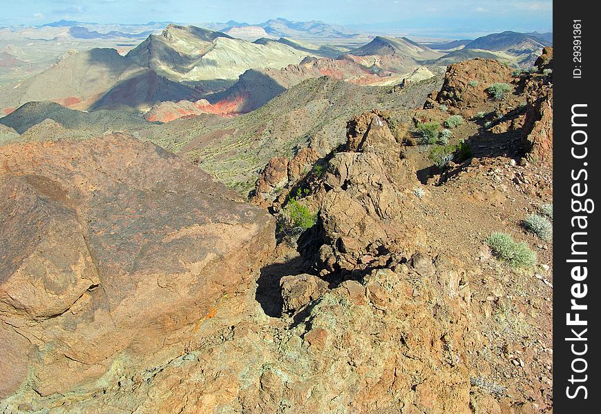 Scenic view of Pinto Valley from the Hamblin Peak near Lake Mead, Nevada. Hamblin Peak is a remnant of an ancient volcano with eroded, solidified magma seen in the foreground. The view is looking east. Scenic view of Pinto Valley from the Hamblin Peak near Lake Mead, Nevada. Hamblin Peak is a remnant of an ancient volcano with eroded, solidified magma seen in the foreground. The view is looking east.