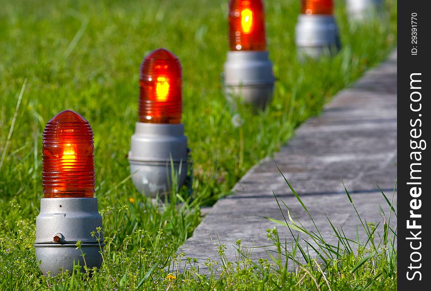 Close-up of guide lights next a helicopter landing pad. Close-up of guide lights next a helicopter landing pad