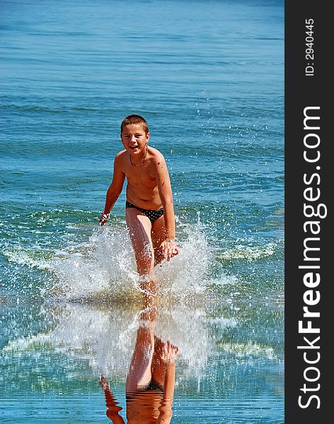 A Boy Running In Water