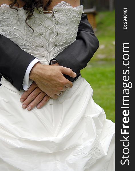 Groom embrace his bride close up