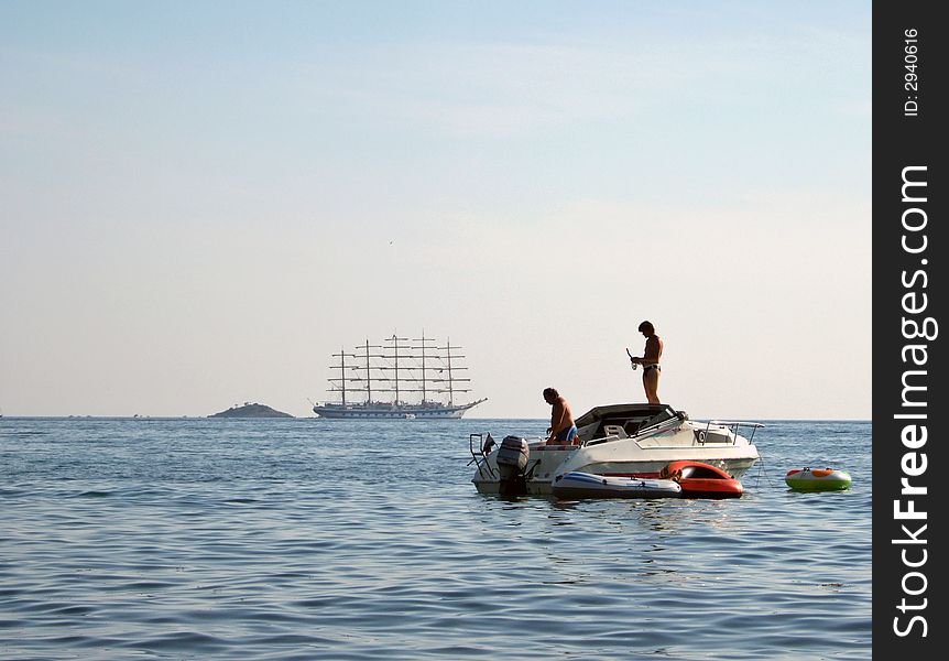 Old and very big sailer and modern motor boat. Old and very big sailer and modern motor boat