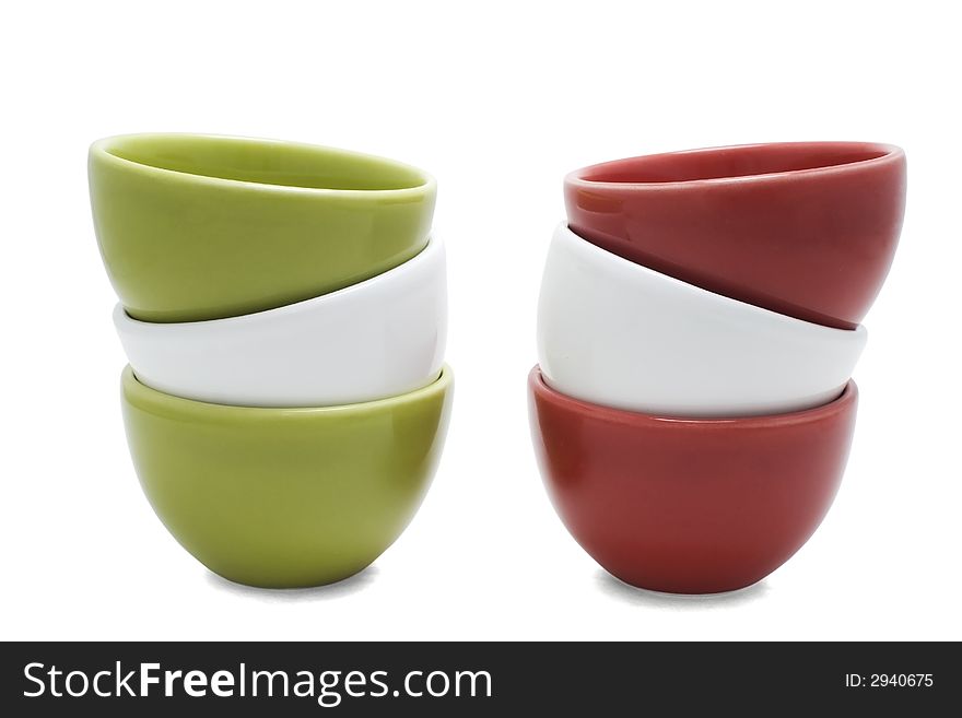 Two piles of stacked red, green white cups isolated on white. Two piles of stacked red, green white cups isolated on white.