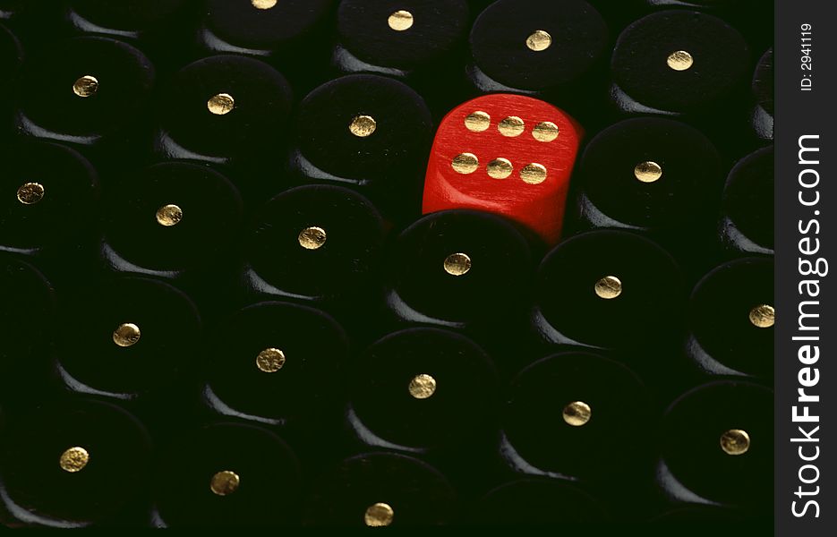 A red dice showing six and a lot of black dices showing one