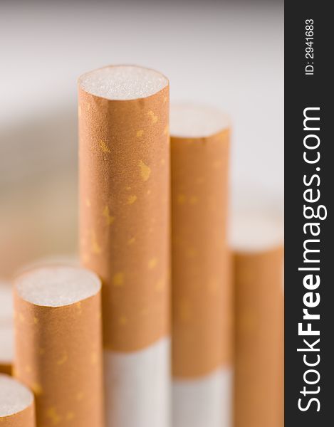 Four Cigarettes  close up background blurred. Four Cigarettes  close up background blurred