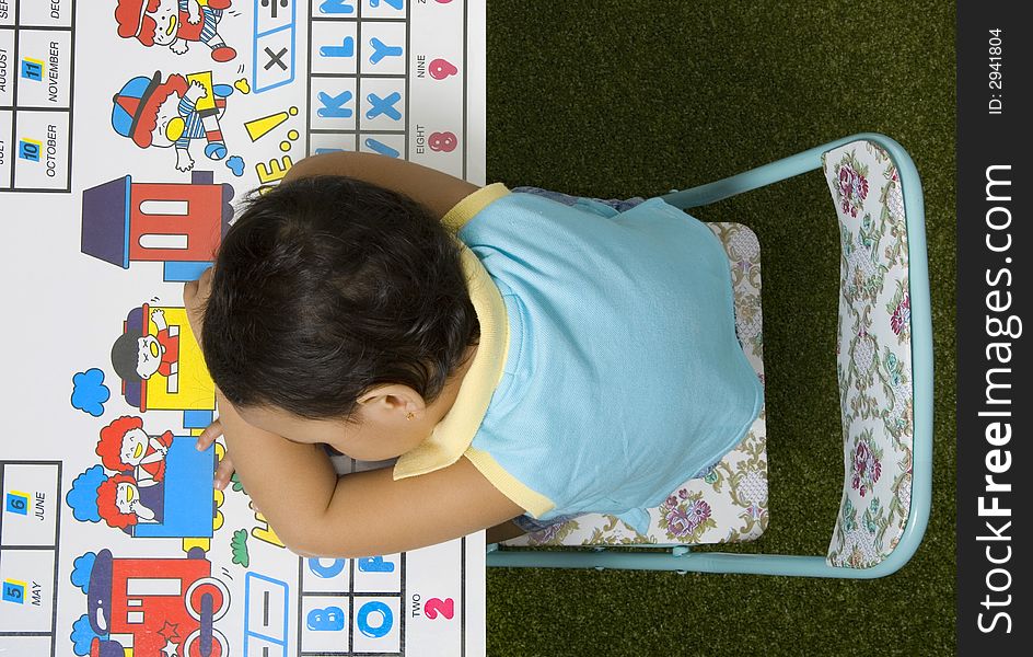 Toddler having a nap at a table