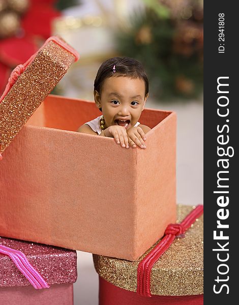 Toddler peeping from a box at christmas. Toddler peeping from a box at christmas