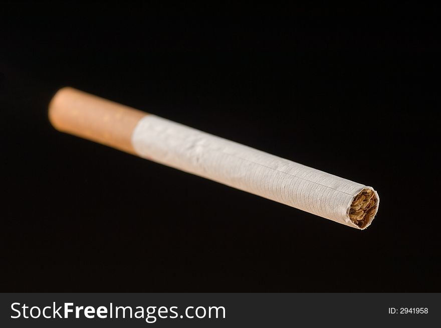 An isolated cigarette on black background