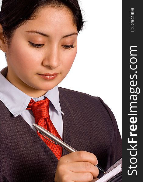 A woman in a business suit writing down her weekly schedule on an organizer. A woman in a business suit writing down her weekly schedule on an organizer