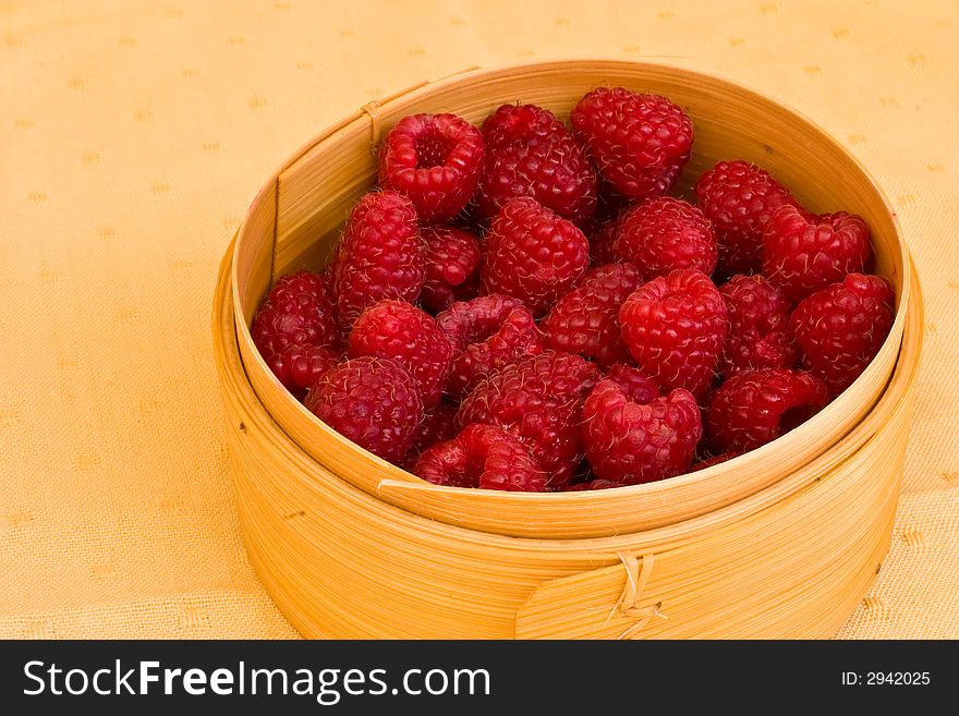 Sweet summer raspberries in the wooden box