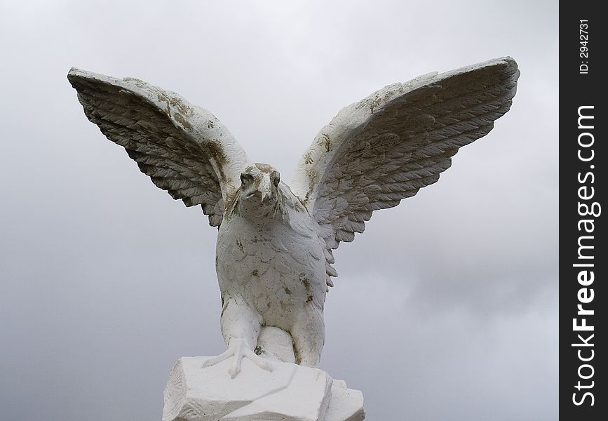 An old sand weathered statue of a falcon. An old sand weathered statue of a falcon