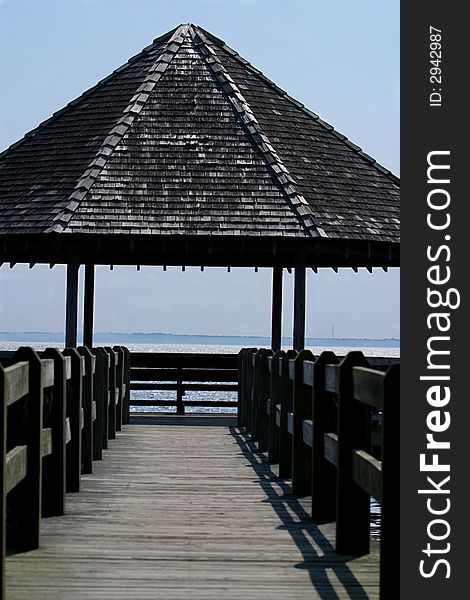 An empty gazebo with an ocean background