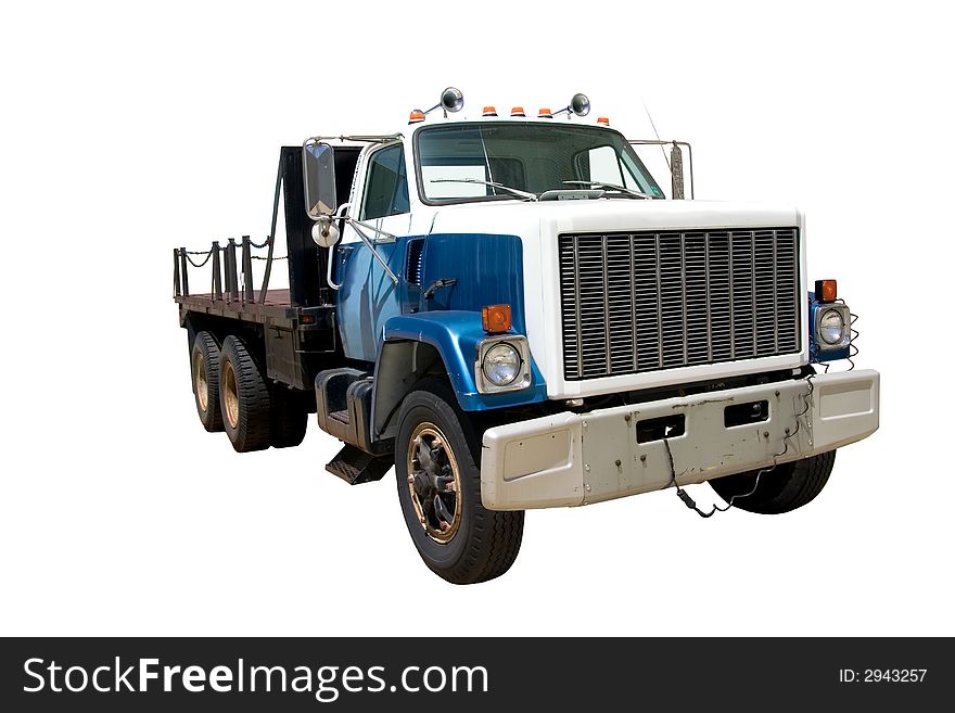 This is a mid 1980's heavy duty flatbed truck viewed from the front corner. isolated on white. This is a mid 1980's heavy duty flatbed truck viewed from the front corner. isolated on white.