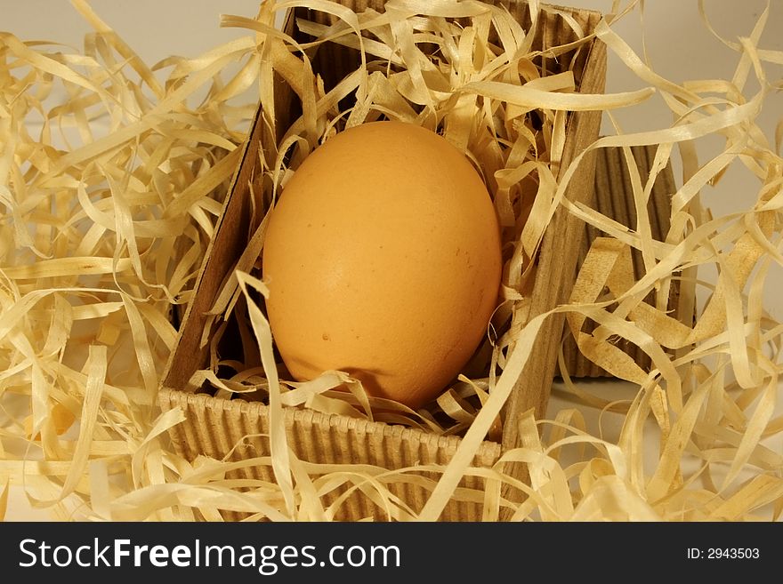 Egg lying in a cardboard box on some straw. Egg lying in a cardboard box on some straw