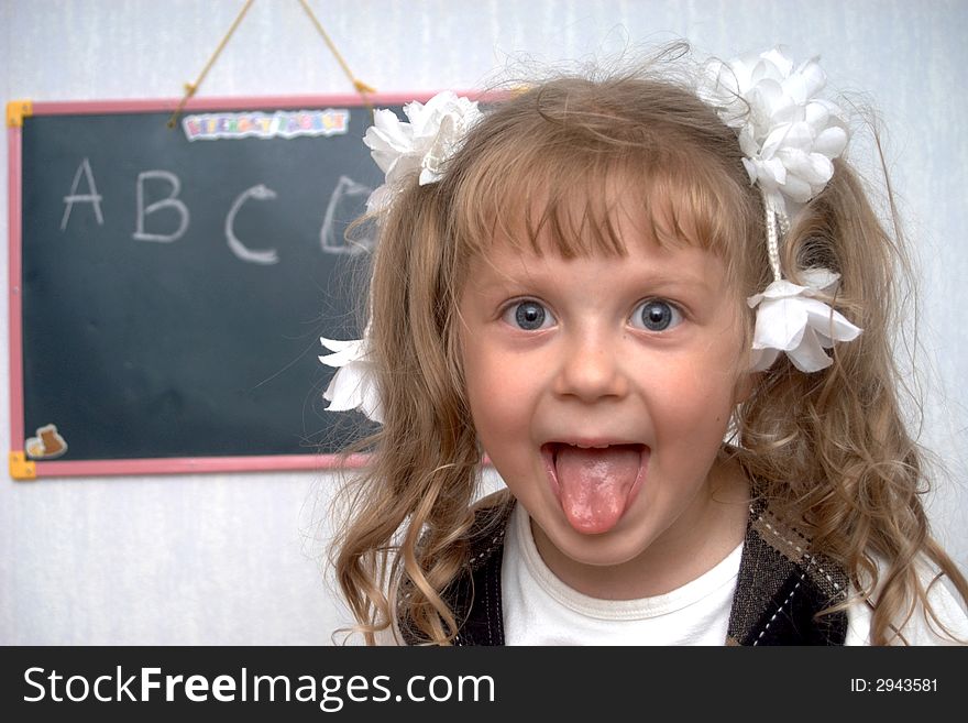 An image of girl on a first lesson at school. An image of girl on a first lesson at school