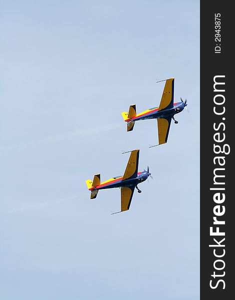 Two airplane doing aerial acrobatics at low altitude. Two airplane doing aerial acrobatics at low altitude