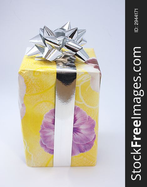 Bright coloured gift wrapping with a silver rozette. Bright coloured gift wrapping with a silver rozette