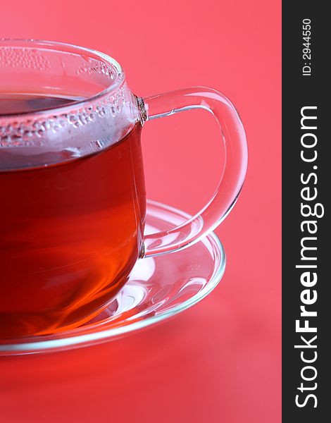 Cup of tea on red background