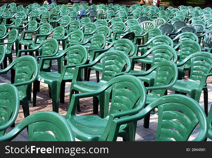 Row of plastic green chairs. Row of plastic green chairs.