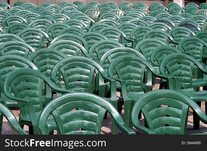 Row of plastic green chairs. Row of plastic green chairs.