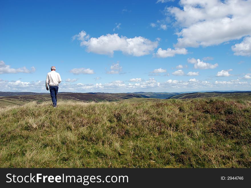 A man taking a walk in the countryside in north wales. A man taking a walk in the countryside in north wales.